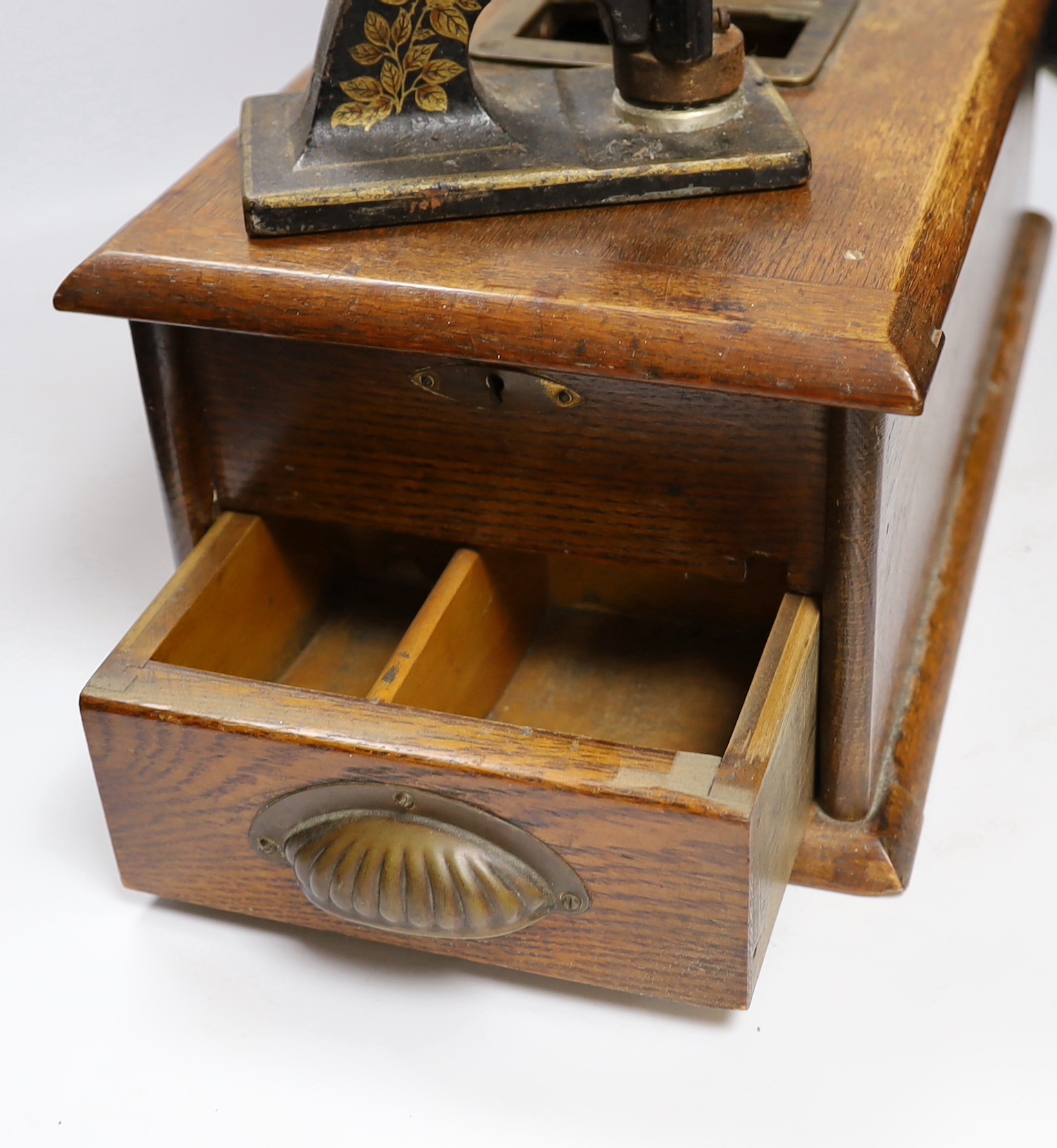 A Victorian oak Till and Company paper stamp from Alex Rice Ltd, formerly Fisher St., Lewes, and a Victorian handbell, largest 46cm wide (3)